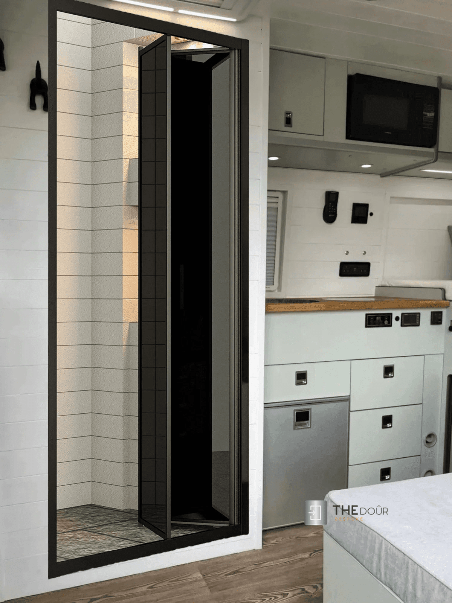 Black FOLdoûr Bi Fold Accordion Aluminium Frame Black Frosted Acrylic Shower Screen Door Designed for a Campervan - THEdoûr Bespoke